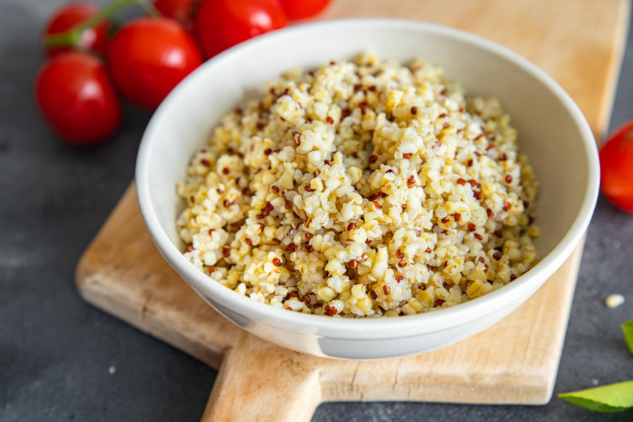 Quinoa in a white bowl showing its distinctive spiral germ pattern